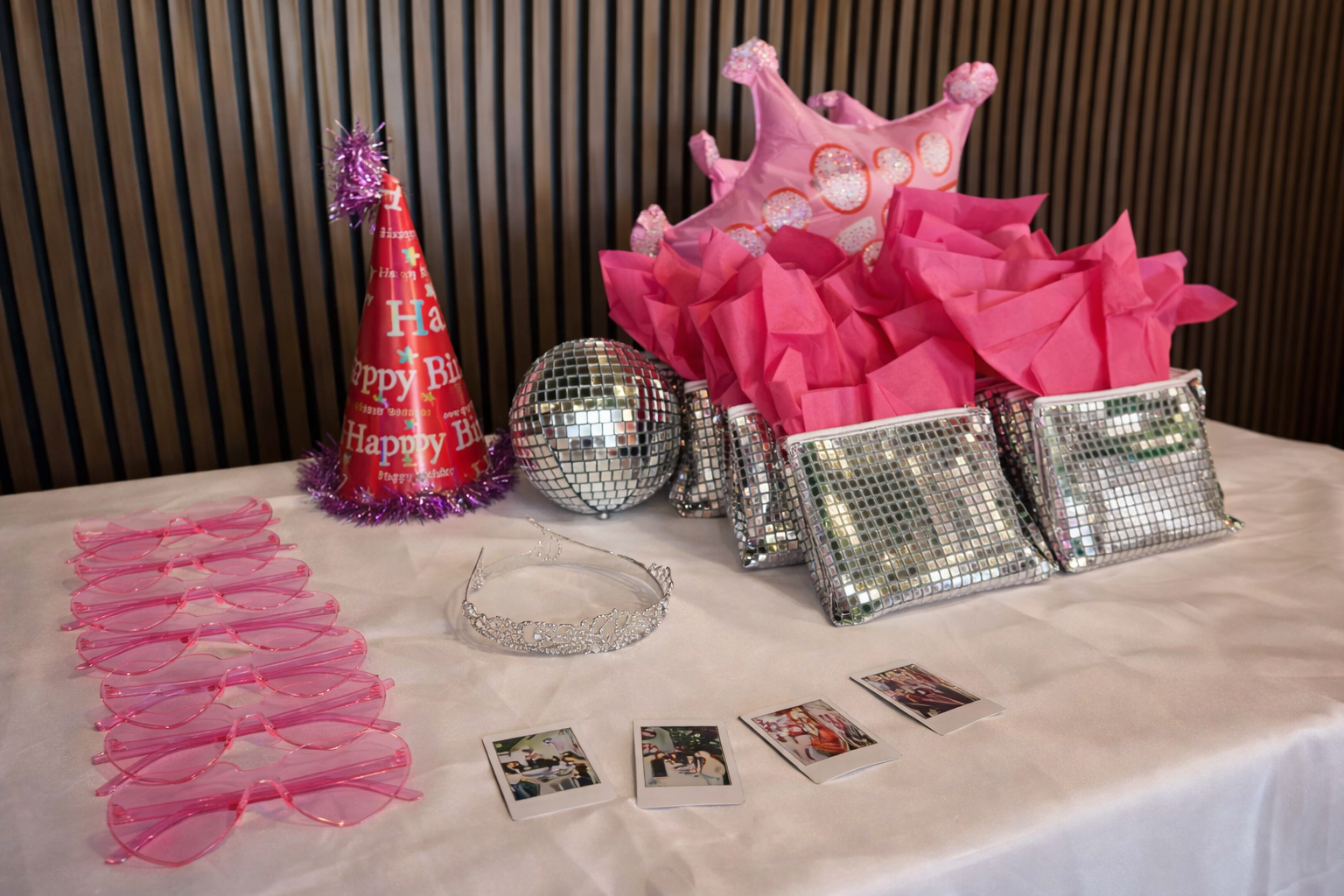 Disco-themed party favors with mirror clutches, pink heart sunglasses and tiara