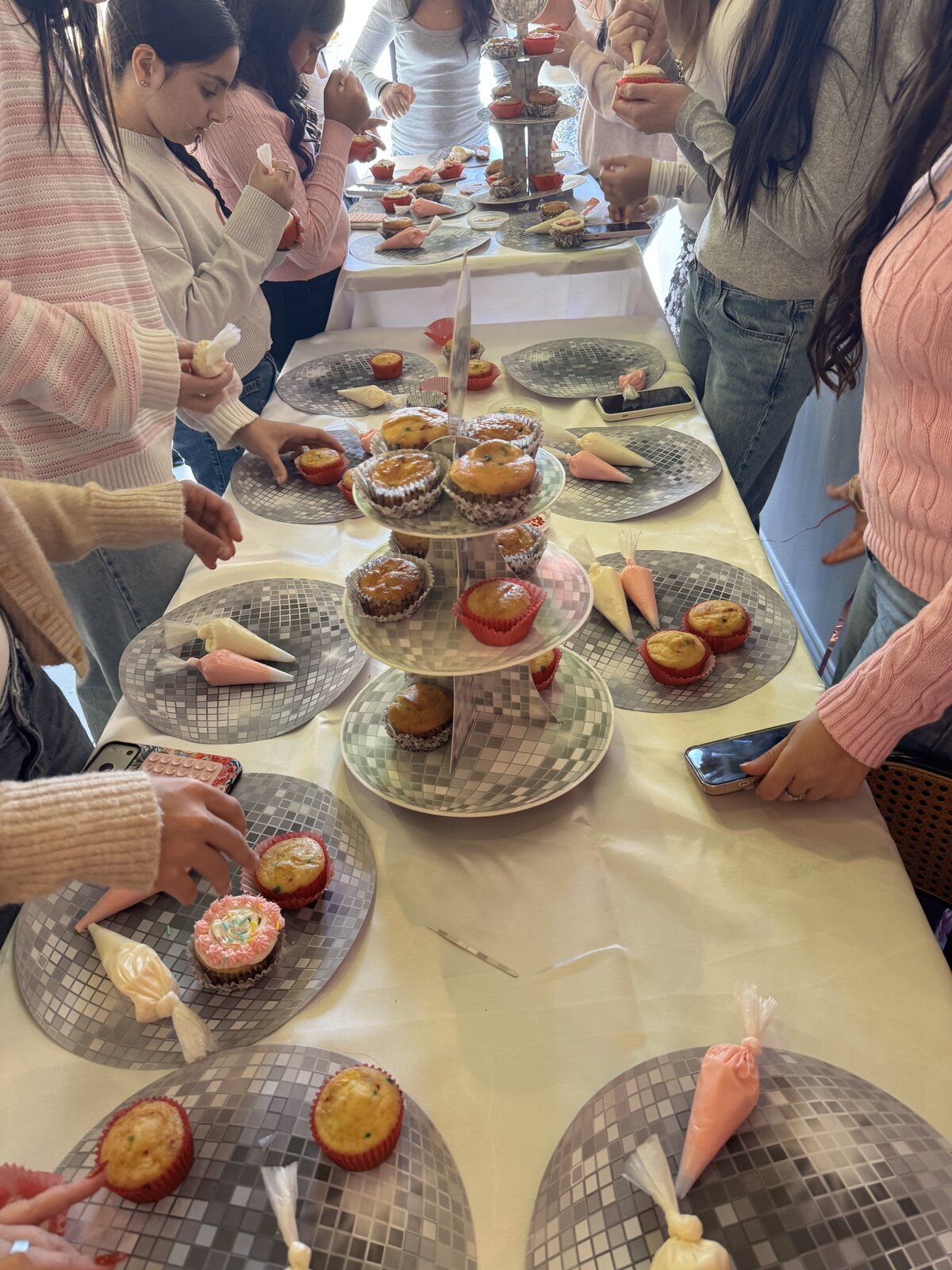Guests decorating cupcakes on disco-ball plates